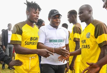Bungoma Governor Kenneth Lusaka (centre), interacts with Bungoma Superstars Football Club players Wilson Werunga (left) and Brian Keya during the launch of the inaugural Governor Lusaka Cup at the Bungoma Airstrip on Monday 27th November, 2023. PHOTO/GPS