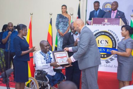 Corporal Edwin Wekoba (centre) receives his Youth Add Value Award by iChange Nations Special Envoy Dr. Ruben West during the ICN Awards held at Siri Tamu Resort, Bungoma, on November 29, 2021. PHOTO/JOSEPH MATERE
